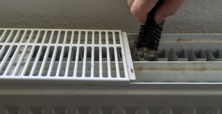 Cleaning a radiator with a radiator brush