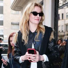 Sarah Pidgeon wearing a leather jacket, white T-shirt, black jeans, and high-vamp shoes during Milan Fashion Week