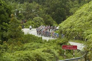 The peloton snake their way around the base of Cameron Highlands slowly reeling in the leading group.