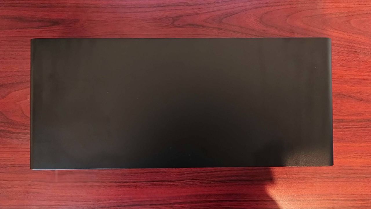 Razer Monitor Stand Chroma lying on woodgrain desk with top facing upwards.