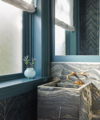 Blue powder room with marble sink by Tracy Morris Design