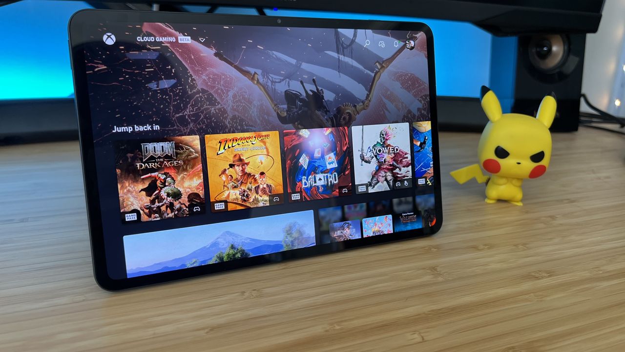 RedMagic Astra gaming tablet running Xbox Cloud gaming on a wooden desk with blue backlighting
