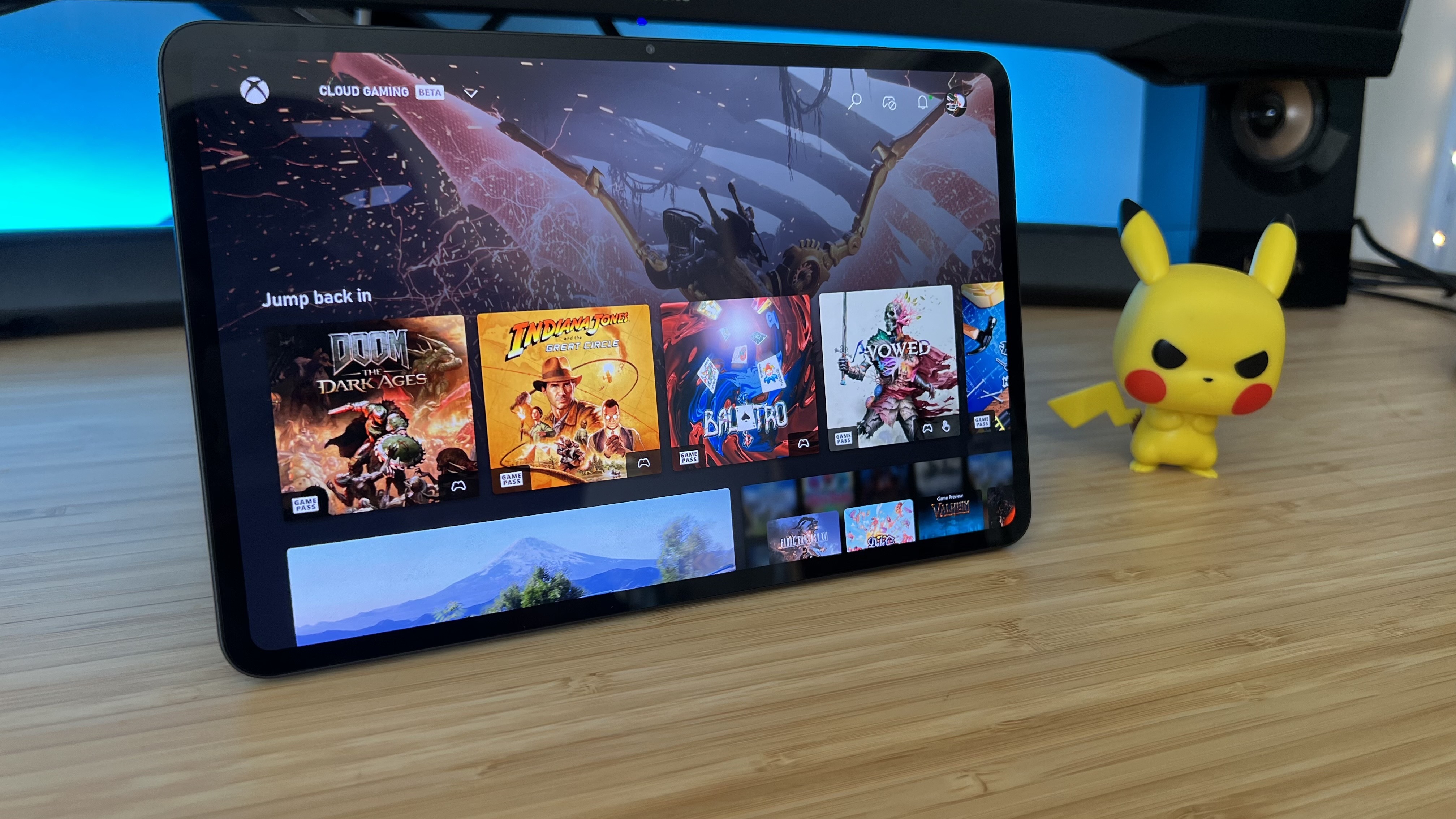 RedMagic Astra gaming tablet running Xbox Cloud gaming on a wooden desk with blue backlighting