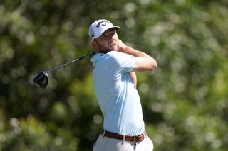 Sam Burns hits his tee shot with a driver