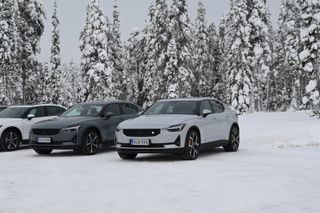 Polestar electric cars in snow in front of snowy trees