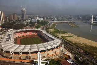 This photograph taken on December 8, 2023 shows a general view of the Felix Houphouet-Boigny stadium and the Alassane Ouattara (ADO) bridge (R) in Abidjan, one of the six stadiums for CAN 2024.