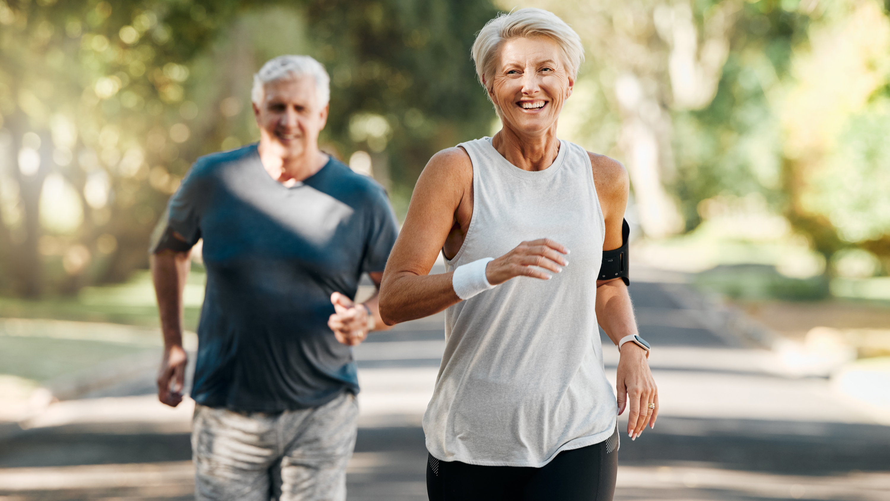 older man and woman running outdoors