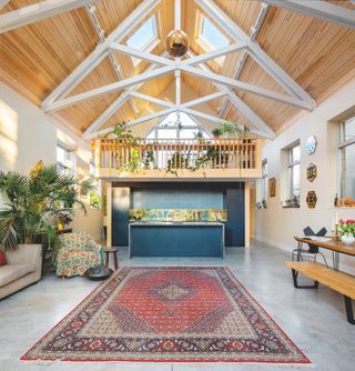 blue kitchen in large chapel conversion with exposed beams