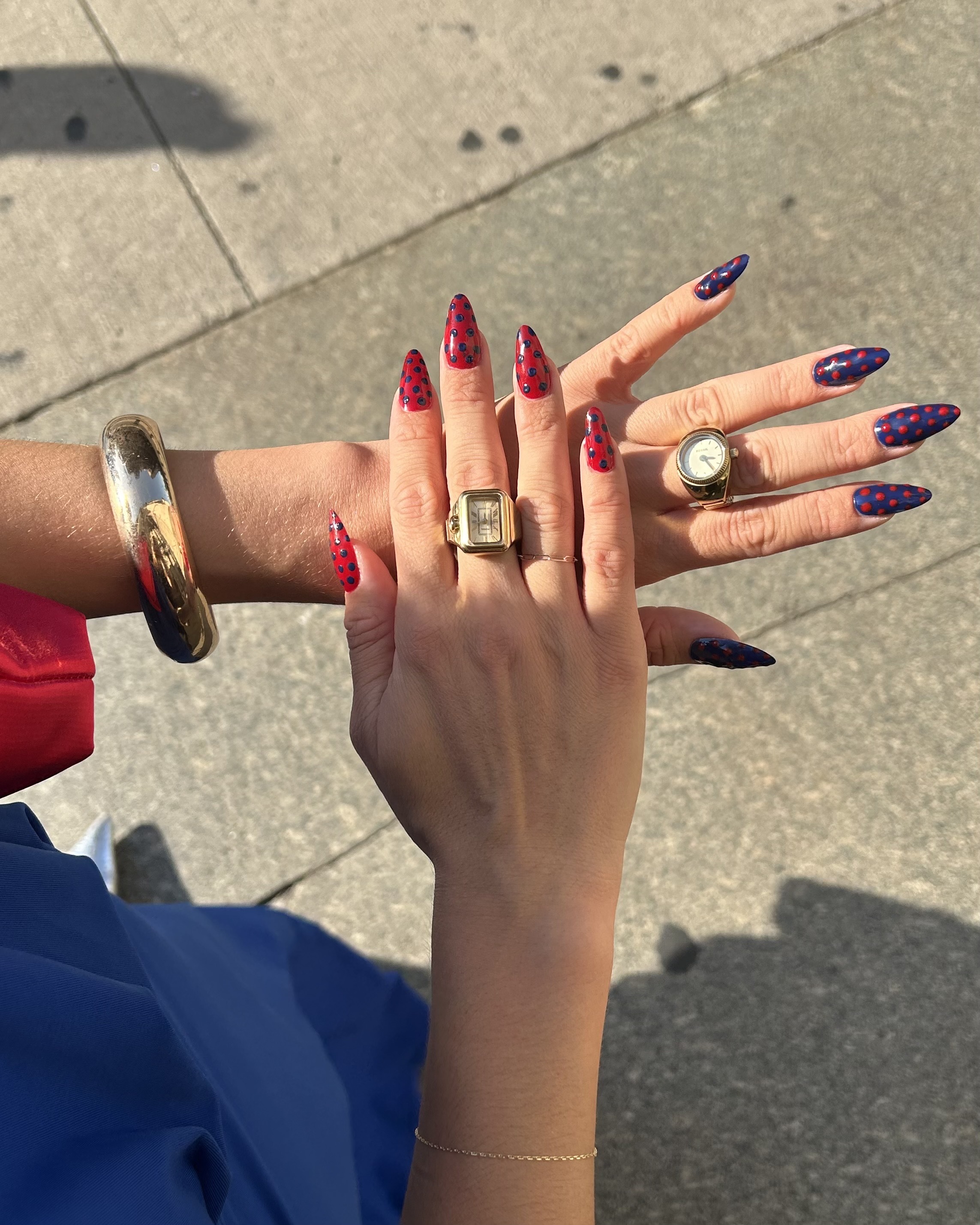 An image of Brascia's red and navy blue polka dot nails.