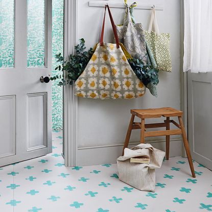 hallway with white wall and door with tiles floor