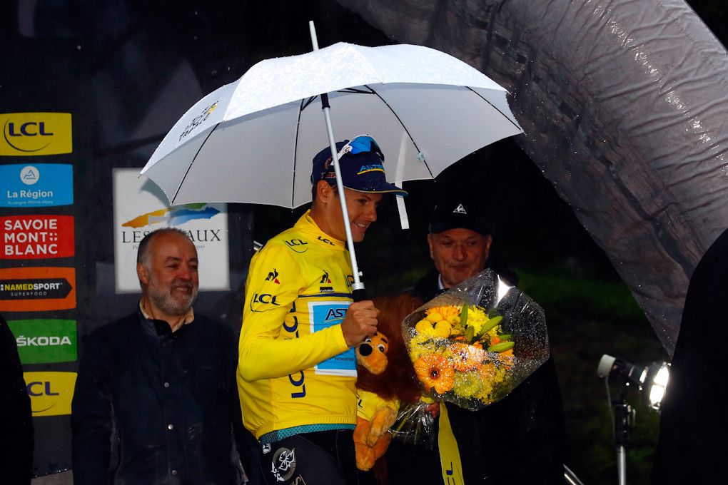 Jakob Fuglsang needed and umbrella to stay dry on the stage 7 podium at Dauphine