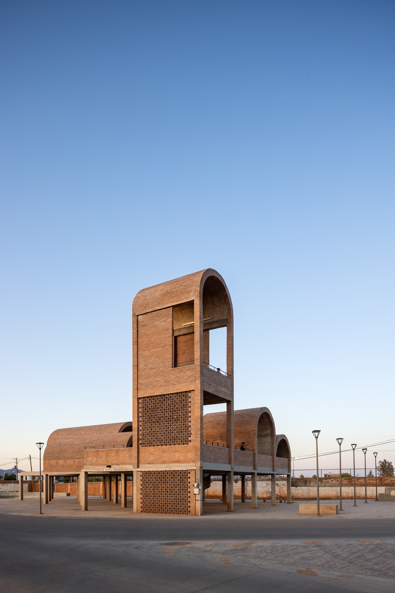 Border Outlook by Fernanda Canales, a brick, textured structure made of vaults and raised platforms