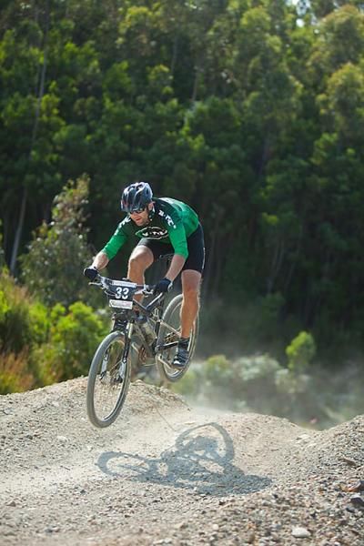 A rider flies over a jump.
