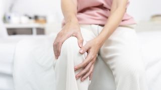 a woman holding her knee