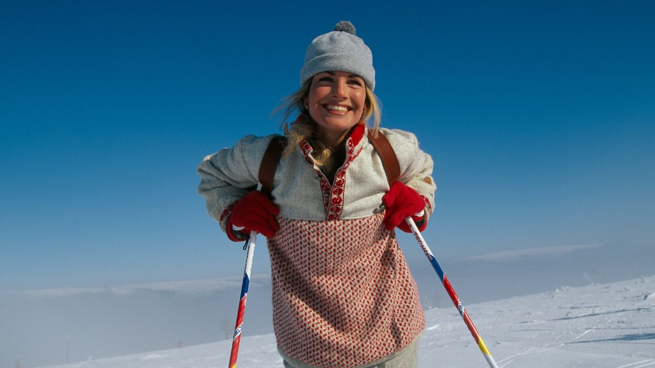 woman skiing with blue background