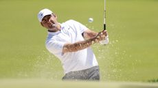 Scottie Scheffler of the United States plays a shot from a bunker on the second hole during a practice round prior to the PGA Championship at Aronimink Golf Club 