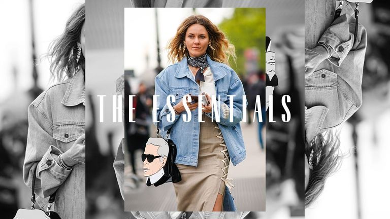 A woman walking down a street wearing a denim jacket. Text over the image reads "The Essentials"