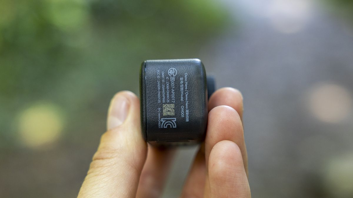 A female photographer holding the DJI Osmo Nano action camera