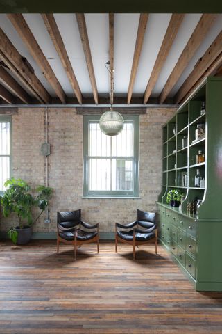 Thames Distillers new home and Fords bar, is an industrial gin brick distillery with a glamorous bar clad in green stone