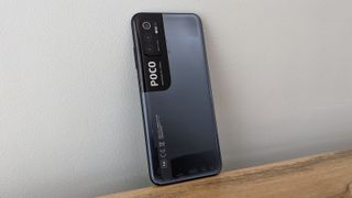 The Poco M3 Pro 5G from the back, on a table