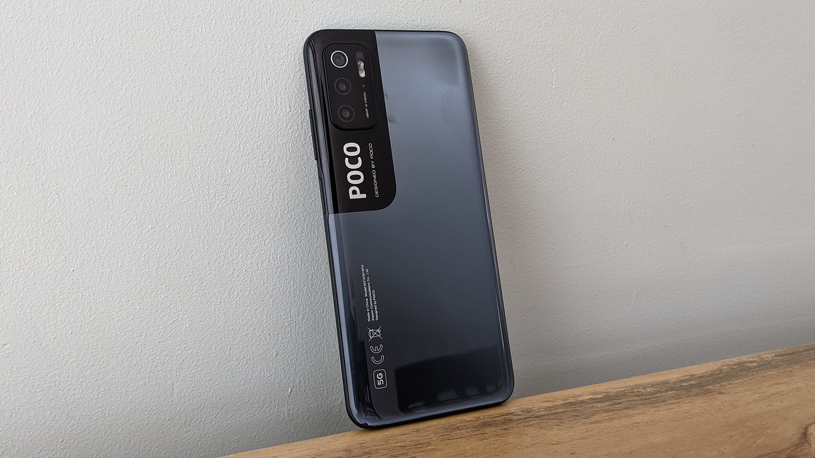 The Poco M3 Pro 5G from the back, on a table