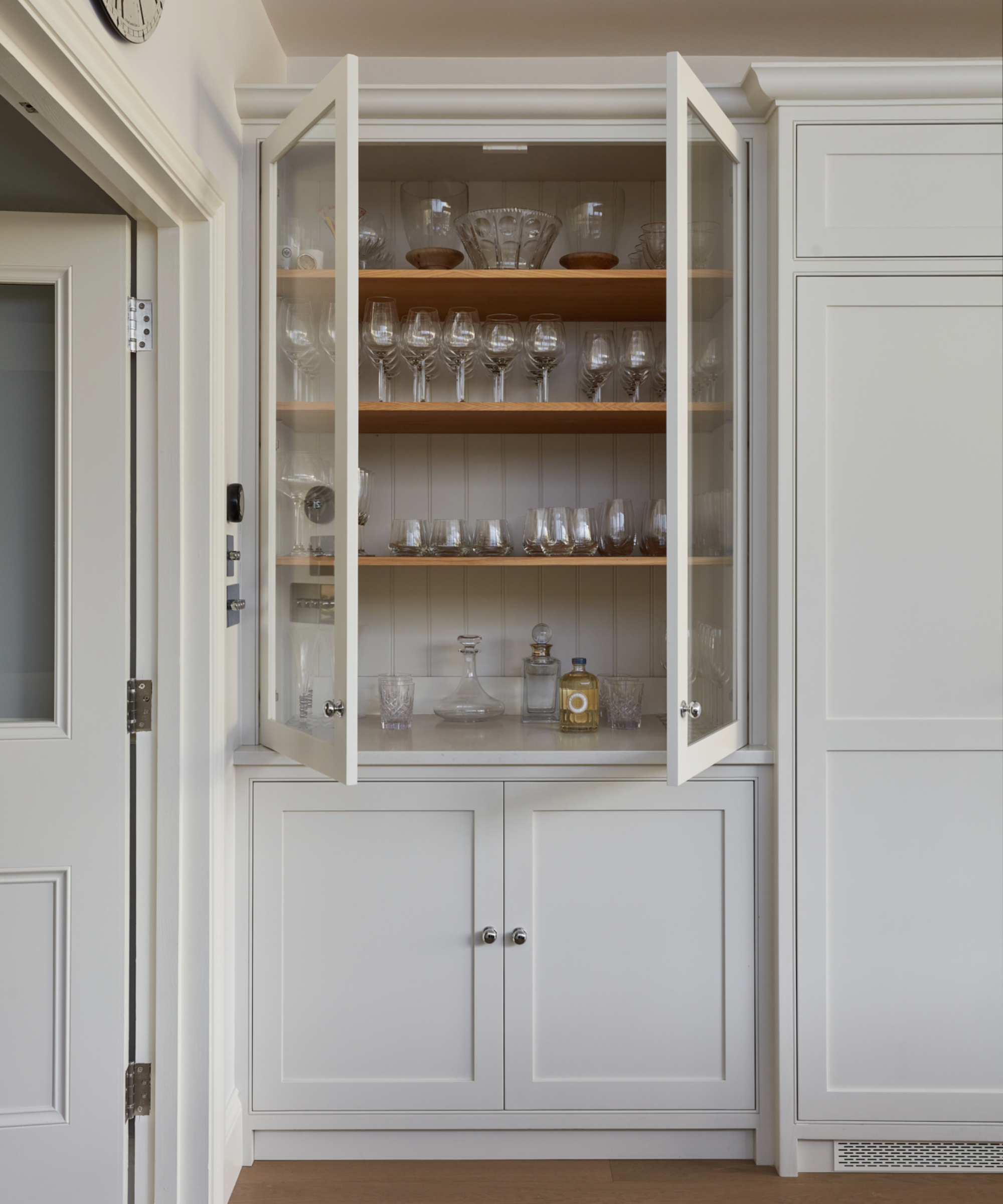 White built-in display cabinet with glass doors