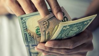 A man counting money by hand