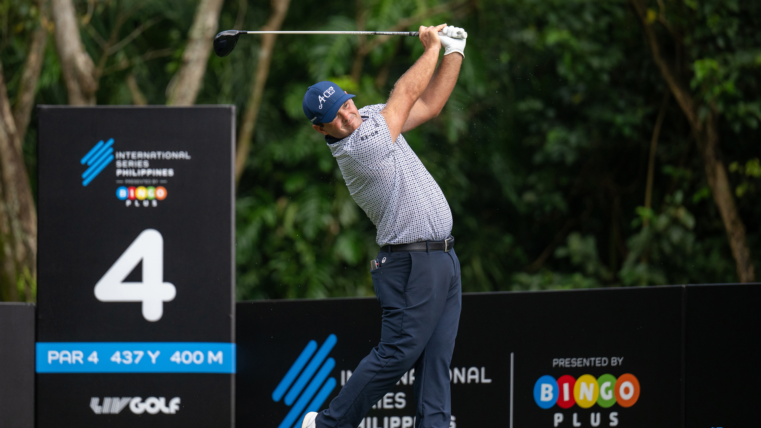 Patrick Reed follows through on a drive at the International Series Philippines