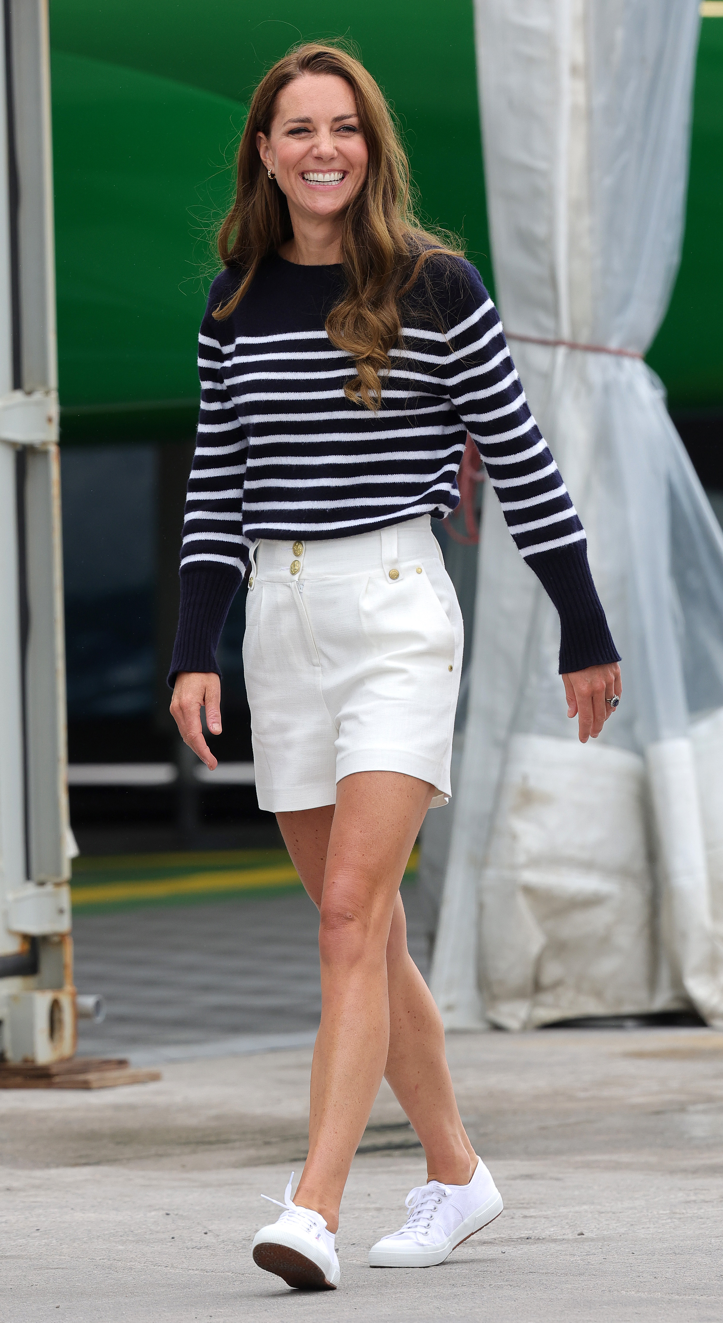 Princess Kate walking wearing shorts and sneakers and smiling