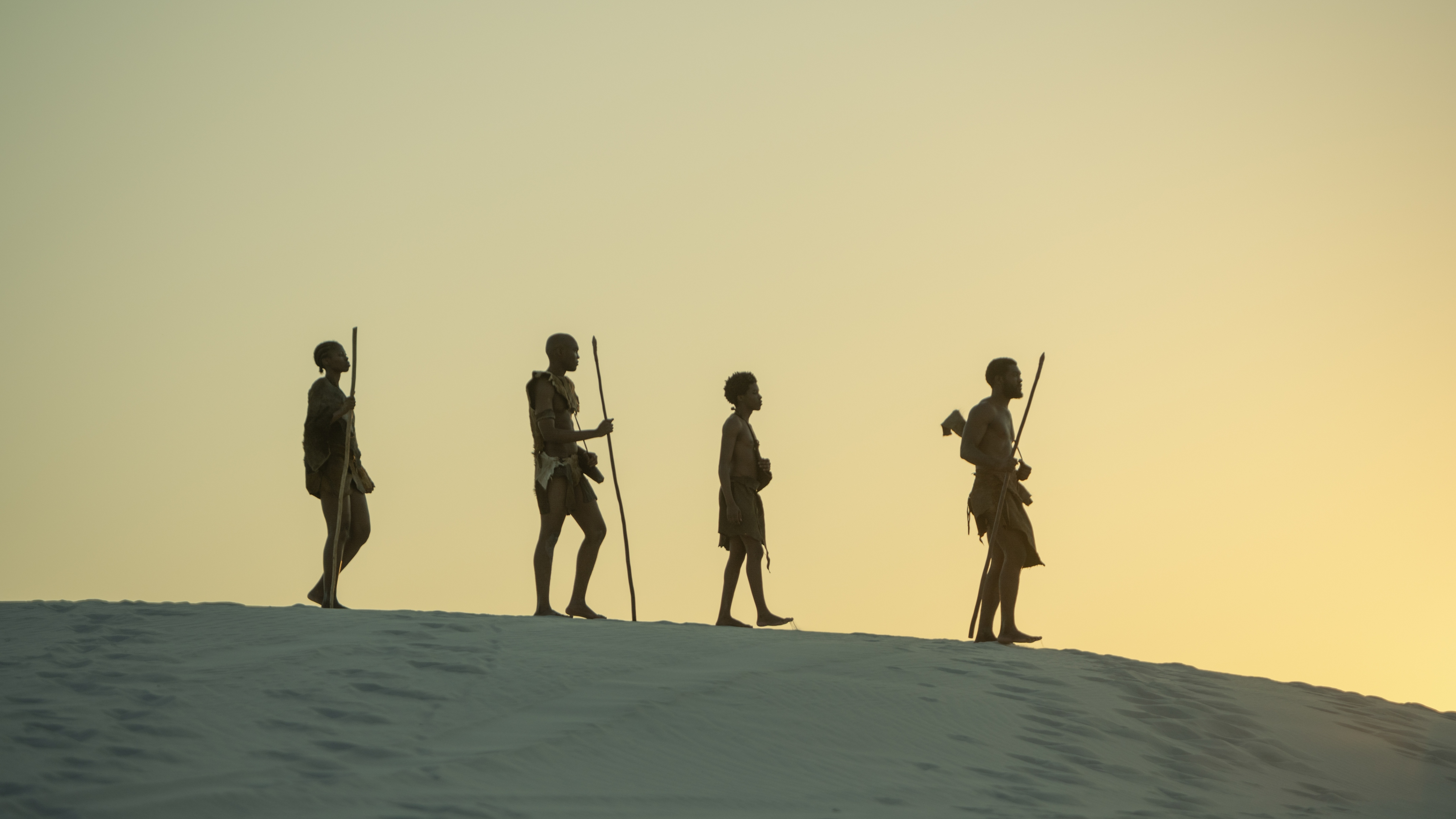 A shot of dramatic reconstruction of early anatomically modern Homo sapiens living in Africa for Human