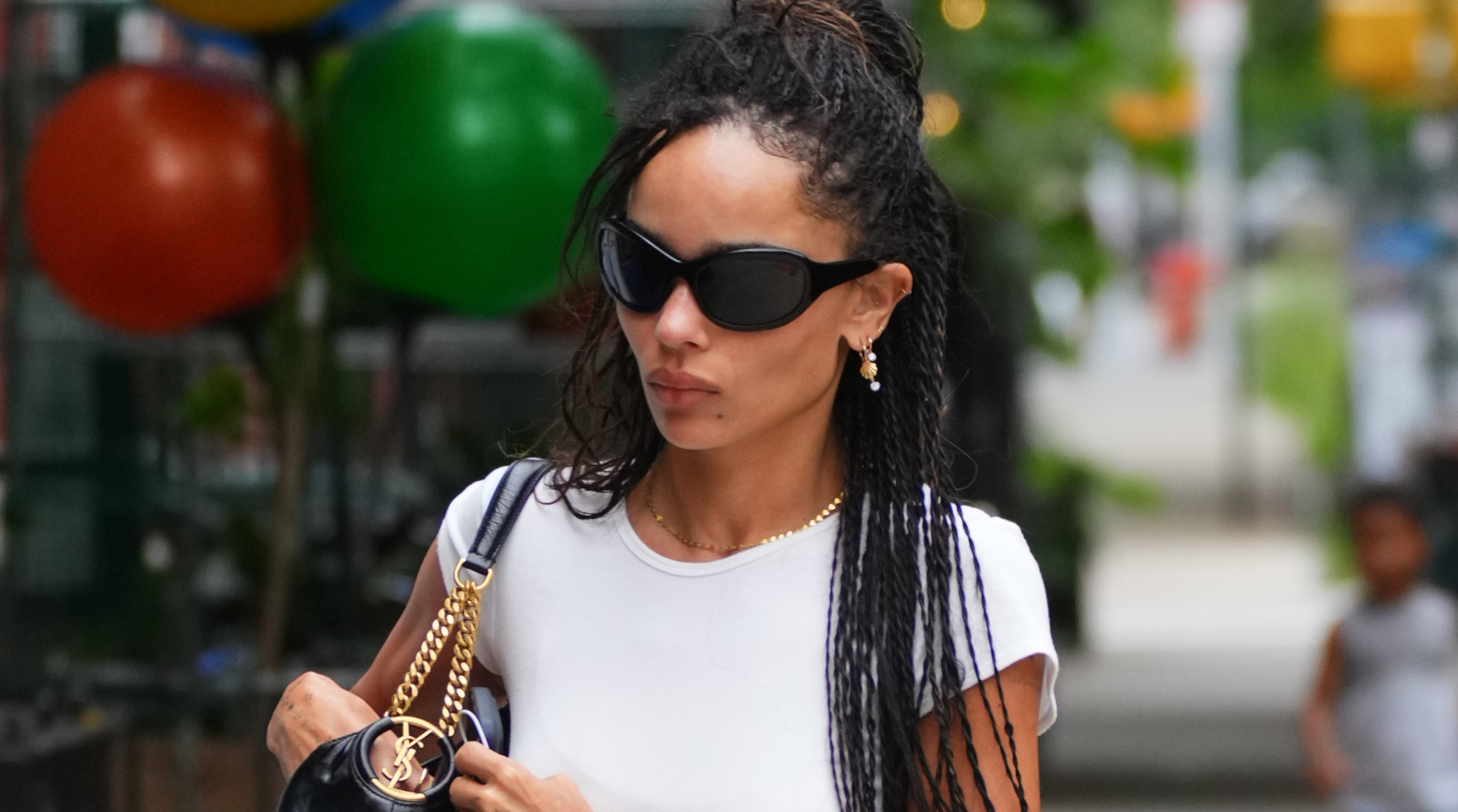 Zoe Kravitz wears the ballet flats trend with distressed jeans and white T-shirt on August 22, 2026 in New York City