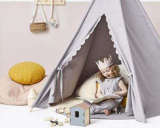 Joules TeePee Play Tent with child playing inside in pink bedroom