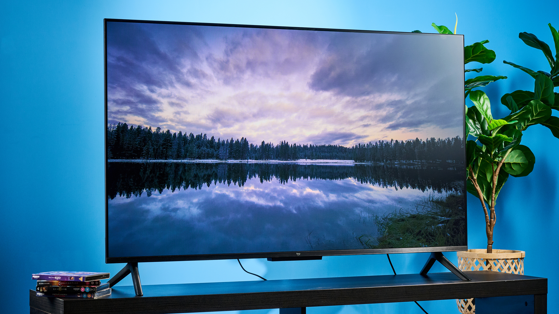 the amazon ember 4-series TV photographed against the blue tom's guide background