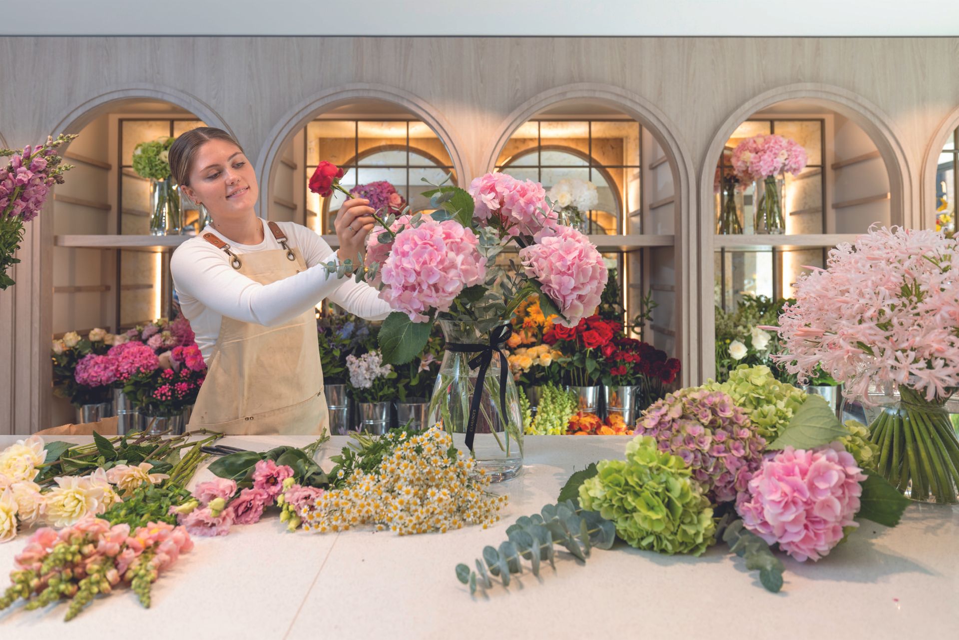 Lexie Welhan arranges flowers at Claridge's
