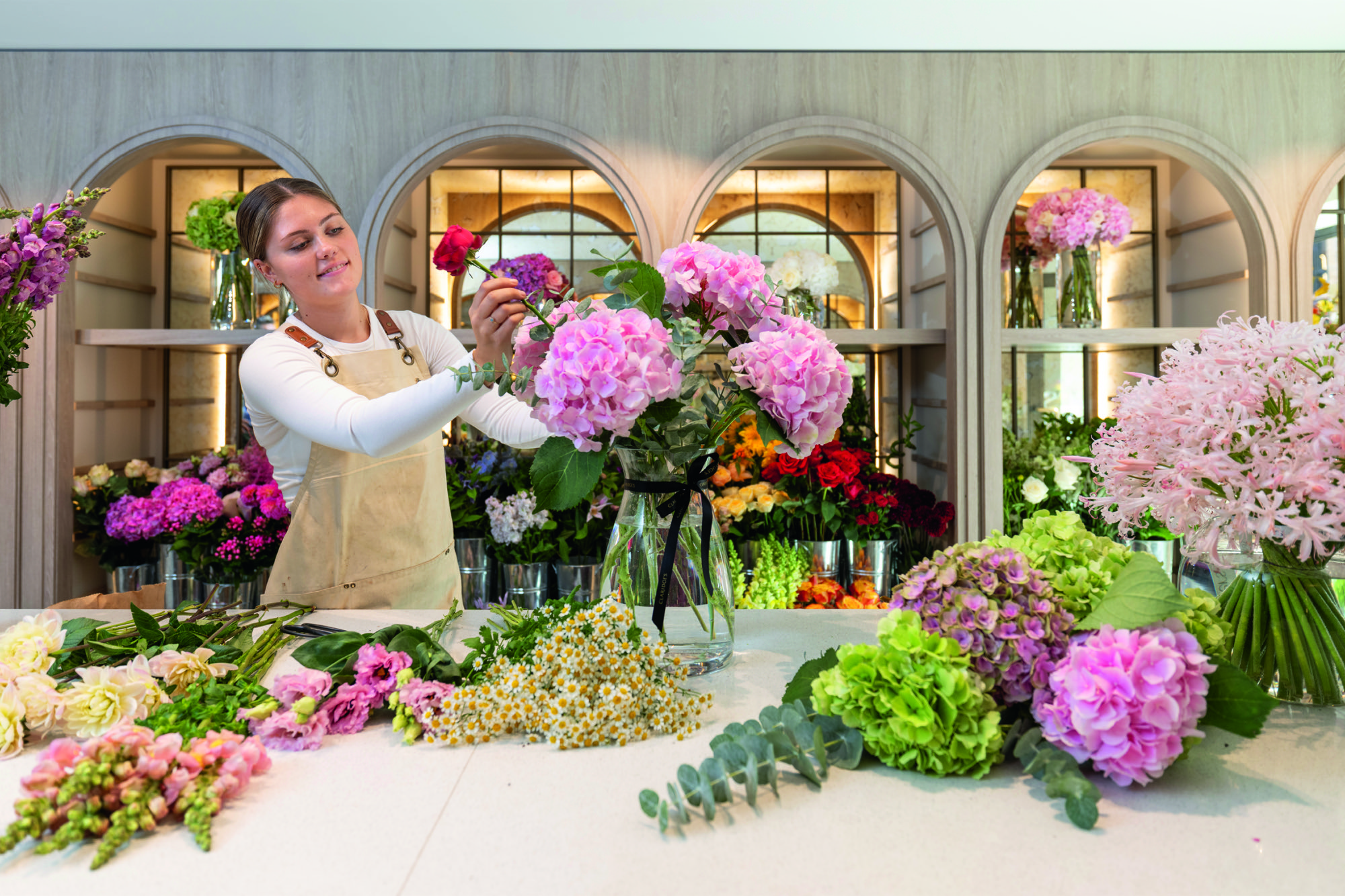 Lexie Welhan arranges flowers at Claridge's