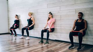 People perform wall sit squat variation