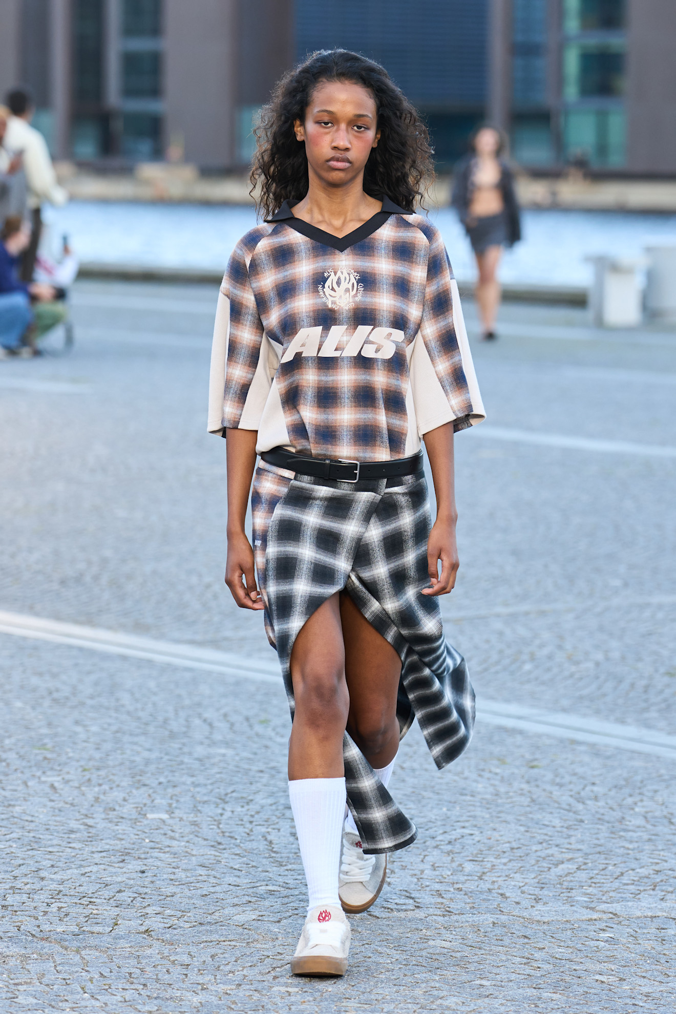 Model wears check tartan prints on spring and summer 2026 runway