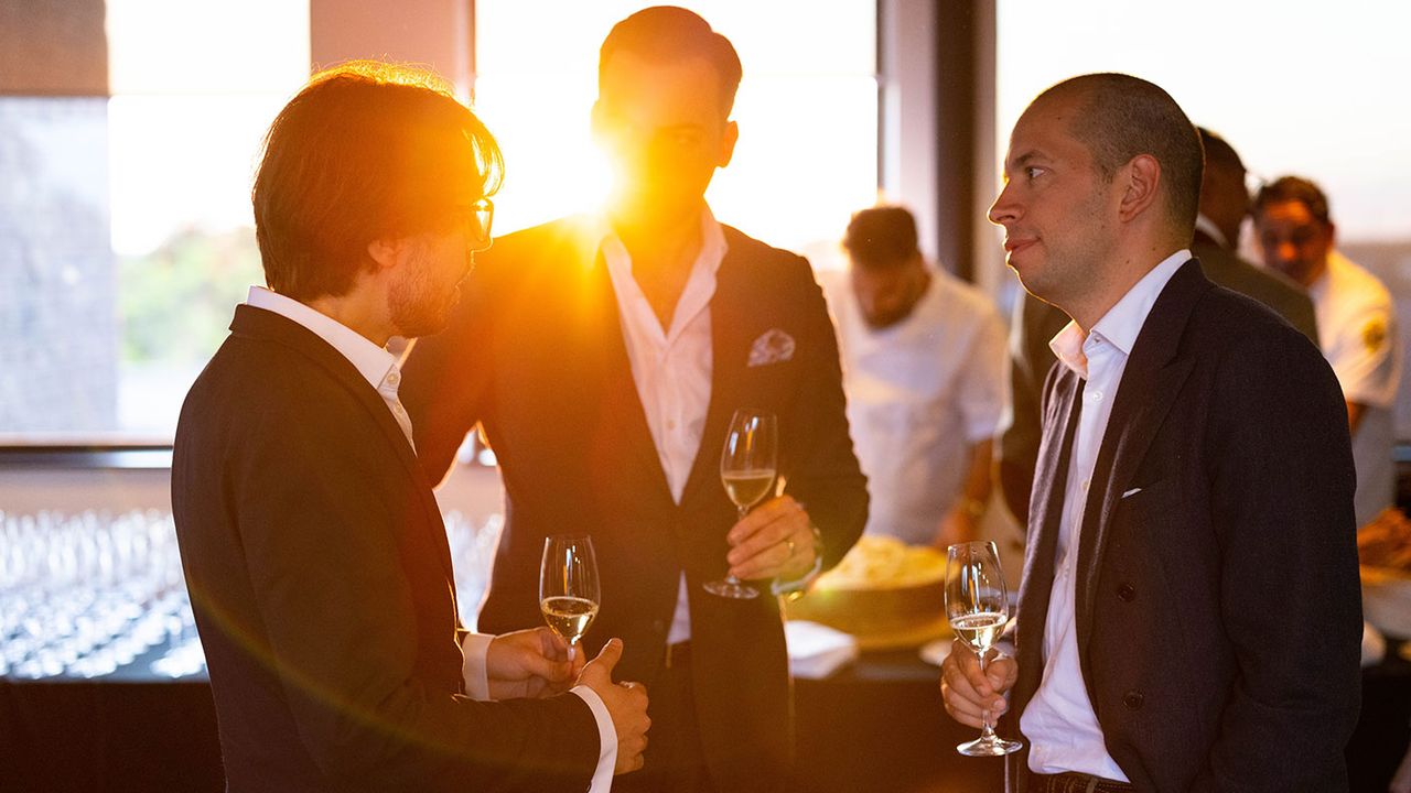 People drinking wine at a function