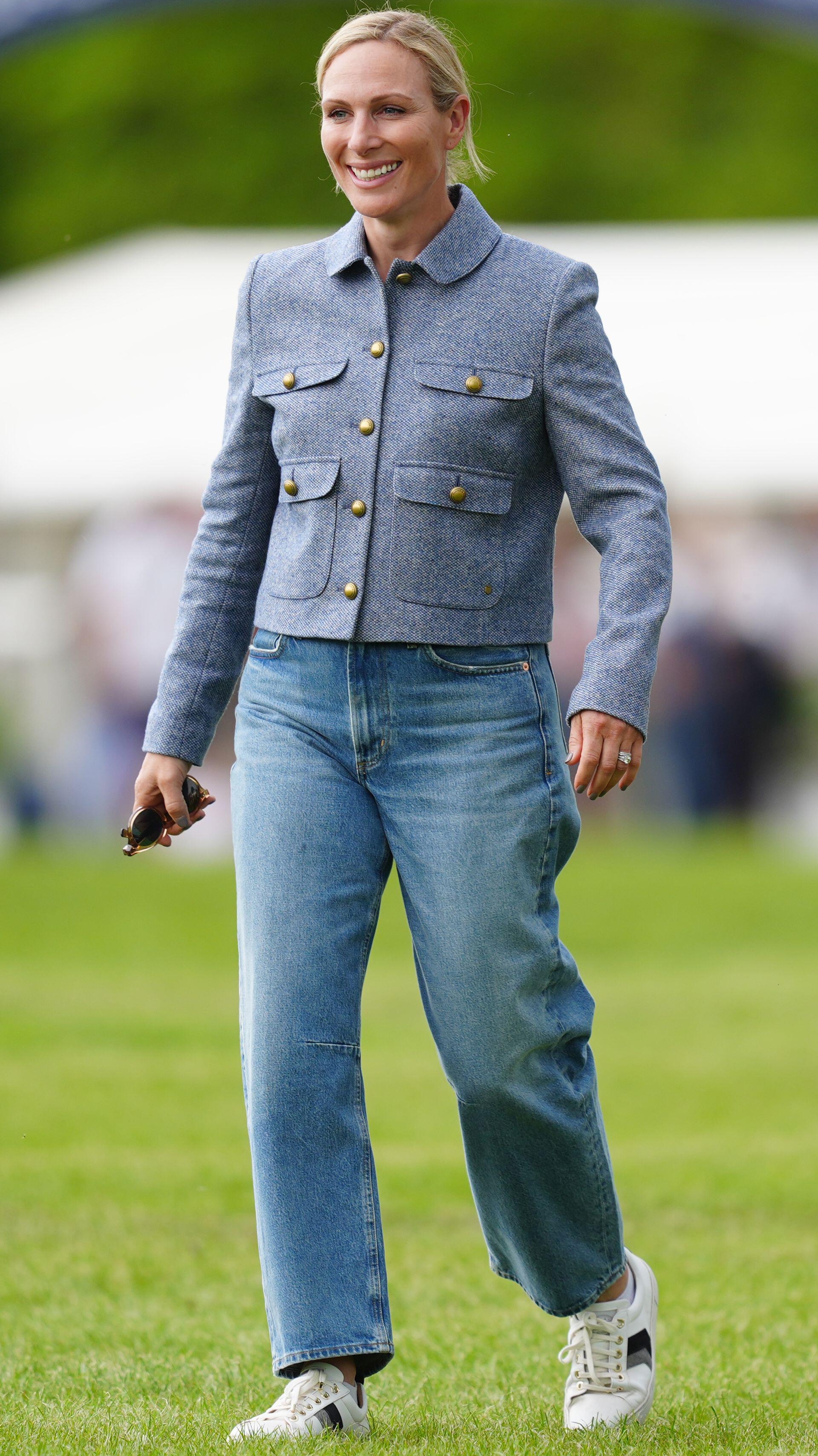 Zara Tindall smiles as she walks across the grass at the Badminton Horse Trials