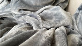 A close-up of the texture of the Lakeland The Snuggler Sleeved Heated Throw