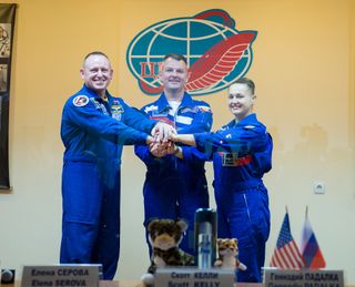 NASA astronaut Barry Wilmore (left) and Russian cosmonauts Alexander Samokutyaev and Elena Serova pose for a crew photo after press conference held at the Cosmonaut Hotel in Baikonur, Kazakhstan on Sept. 24, 2014. They will launch from Baikonur Cosmodrome