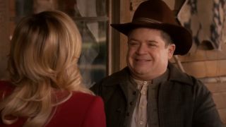Patton Oswalt smiling at Amy Poehler on Parks and Recreation.