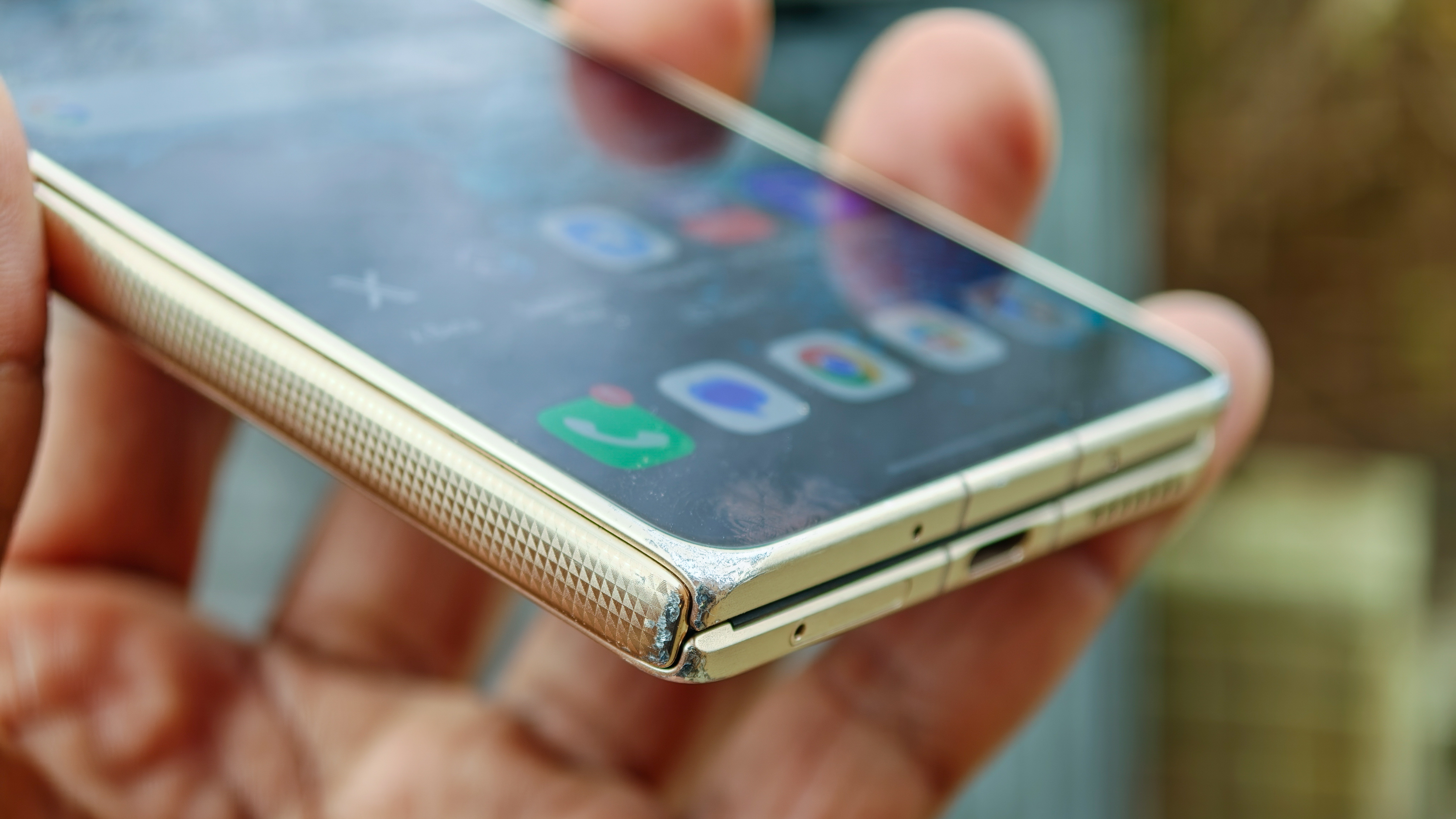 The Honor Magic V6 in gold after being put through a washing machine, complete with scratches and blemishes but fully working. 