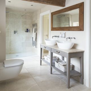 bathroom with stone tiled walls and white washbasin