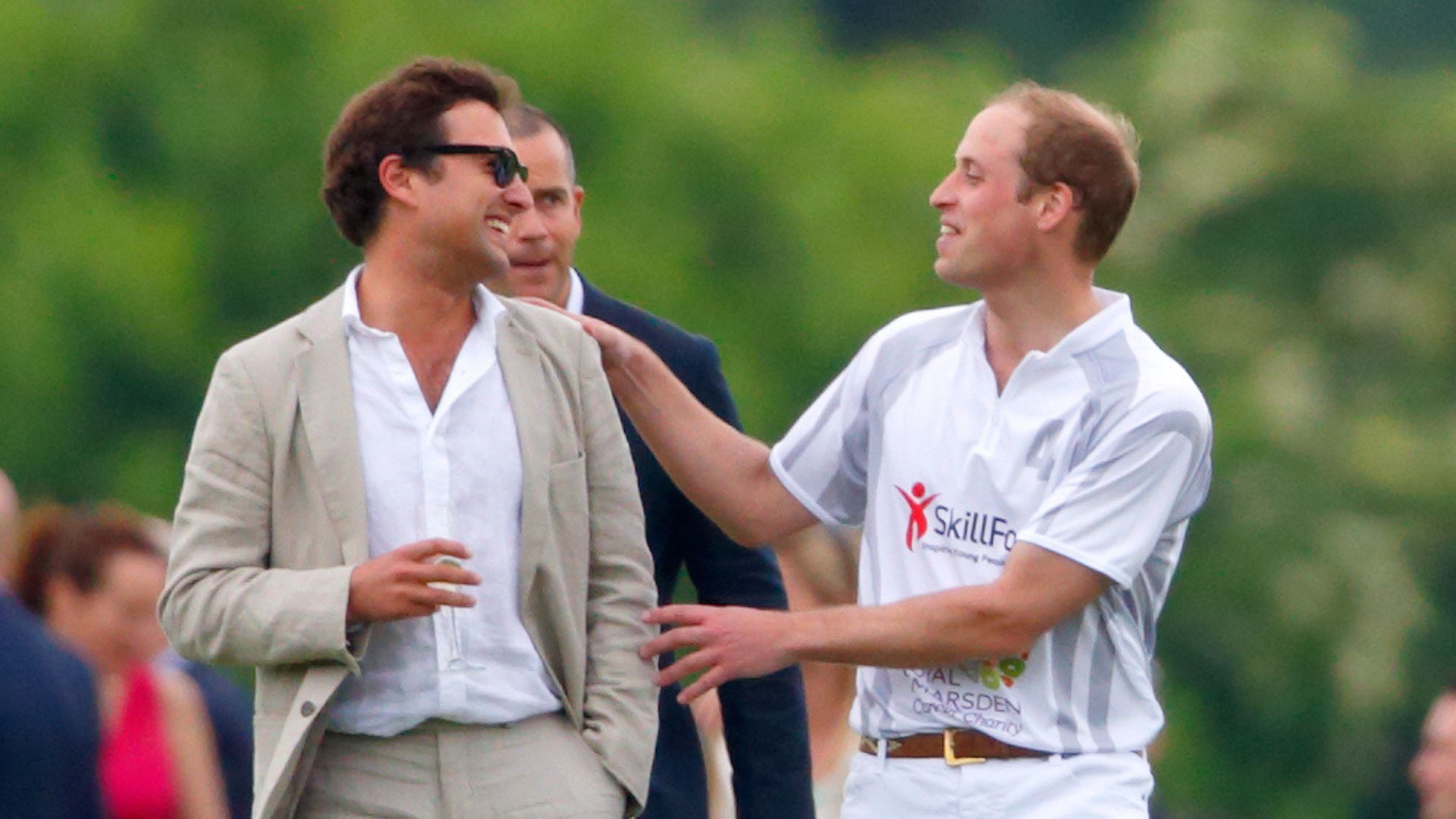 Prince William talks with Thomas van Straubenzee after playing in the Audi Polo Challenge at Coworth Park Polo Club on May 31, 2014