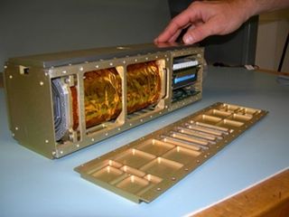 Sara Seager brought to the panel discussion a model of a lower-cost nanosatellite dedicated to exoplanet discovery. This image reveals the inner workings of a standard nanosatellite.