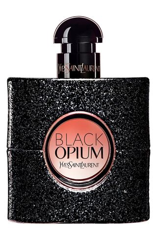 Black Opium Eau De Parfum in square shaped glittery black bottle with pink gradient circular label and small circular black cap on white background 