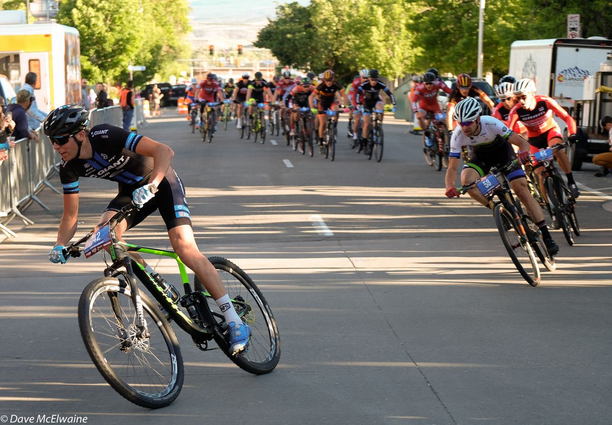 A Giant rider taking a flier with the strung-out peloton closing in