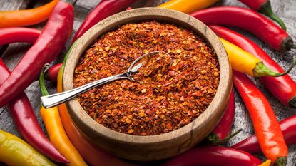 Red pepper flakes in a bowl with a spoon