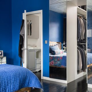 bedroom with blue wall and mirror